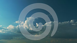 Scattered Clouds In Blue Sky. White Gold Clouds In A Blue Sky With Rays Of Sun Coloring Parts Of Cloud.