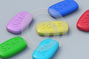 Scattered colorful soap bars on gray background. Laundry accessories. Handmade antibacterial agent. Cleaning and hygiene