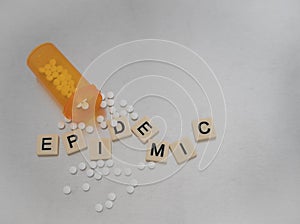 Scattered Epidemic and Bottle of Pills on Stainless Steel