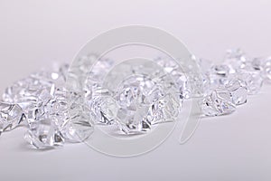 Scattered glass diamond chunks on a white background