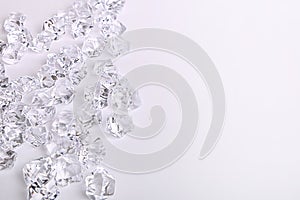 Scattered glass diamond chunks on a white background