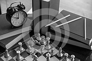 Scattered items in cunning and clever business concept with chess match in black and white with copyspace. Wise leader wins