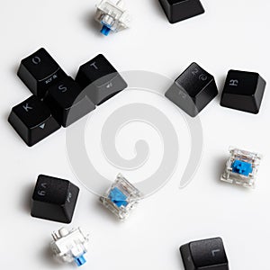 Scattered Keycaps and Keyswitches for Mechanical Keyboards On White Background