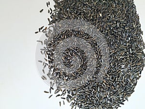 Scattered niger seed with shallow depth of field. Pile and heap of Black Color Uchellu/Gurellu. These seeds are used in masalas by