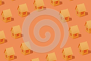 Scattered orange model houses around circular copyspace