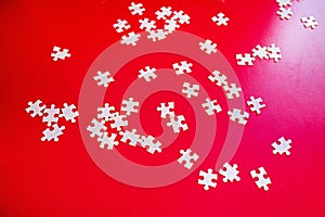 scattered puzzles on a red background. Business Building