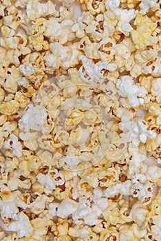Scattered salted popcorm, texture background.