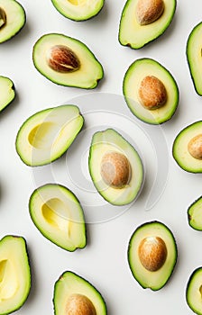 Scattered sliced avocado on white background