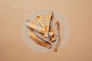 Scattered sticks of Palo Santo tree on a nude background. View from above.