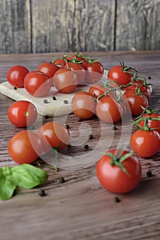 Scattered tomatoes on the wooden table.