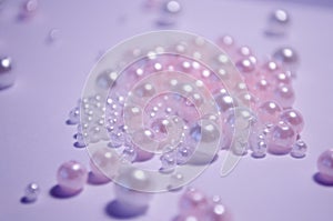 A scattering of beads close-up. White. Transparent. beads of different sizes. Beads on a white background. Materials for jewelry photo