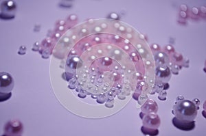 A scattering of beads close-up. White. Transparent. beads of different sizes. Beads on a white background. Materials for jewelry photo