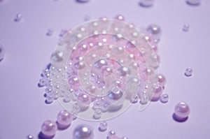 A scattering of beads close-up. White. Transparent. beads of different sizes. Beads on a white background. Materials for jewelry