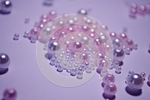 A scattering of beads close-up. White. Transparent. beads of different sizes. Beads on a white background. Materials for jewelry