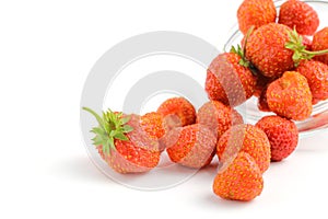 A scattering of berries of organic sweet strawberries on a white background, close-up, isolate. Place for text, copy space