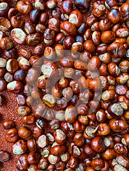 Scattering of chestnuts without shells on an orange background