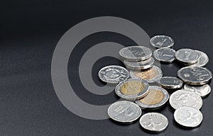 A scattering of coins on a black background