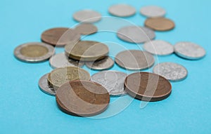 A scattering of coins on the blue background