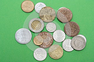 A scattering of coins on a green background