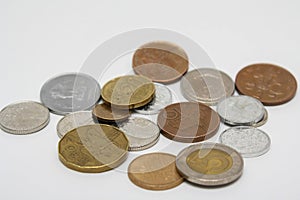 A scattering of coins on a white background