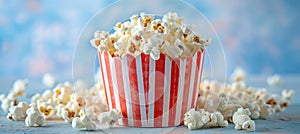 Scattering delicious popcorn from pink striped box on pastel background with copy space