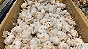 A scattering of garlic on the counter of a vegetable store.