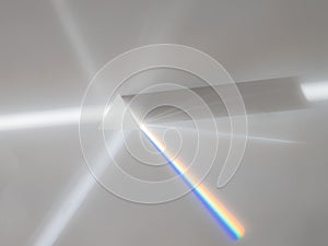 Scattering of a ray of sunlight white light through a prism creating refraction