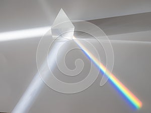 Scattering of a ray of sunlight white light through a prism creating refraction photo