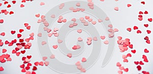 A scattering of red hearts on a white background. Texture for Valentine`s day