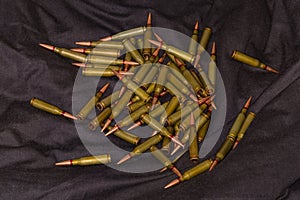 Scattering of the rifle cartridges on a black textile surface