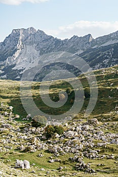 Scattering of stones against the background of a mountain range on the Sedlo Pass in Durmitor National Park