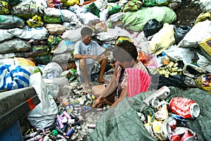 Scavengers preparing segregated recyclable waste products to be sold to recycling facilities