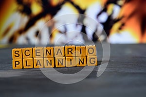 Scenario planning on wooden blocks. Cross processed image with bokeh background