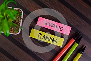 Scenario Planning write on sticky notes isolated on Wooden Table