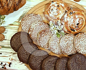Scene with an assortment of baking, original Nuremberg gingerbread cookies on a wooden textured white background