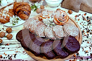 Scene with an assortment of pastries, original Nuremberg gingerbread cookies, rolls, croissants with ingredients. Top view