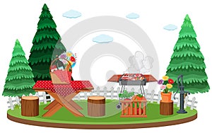 Scene with BBQ grill and food on picnic table in the park