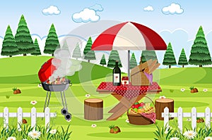 Scene with BBQ grill and food on the picnic table in the park
