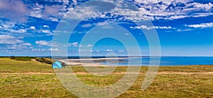 Scene of beach side with cloudy sky, saturated colors