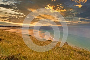 Scene of beach side with cloudy sky, saturated colors