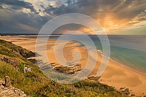 Scene of beach side with cloudy sky, saturated colors