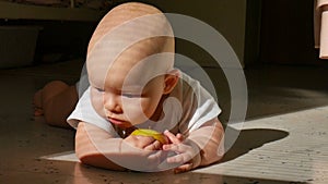 Scene of a beautiful little baby lying on the floor with green and red apple