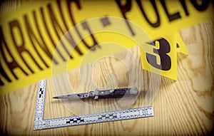 Scene of crime, razor spotted with blood, rule of ballistic measurement, conceptual image