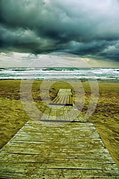 Scene of an empty sandy beach before the storm