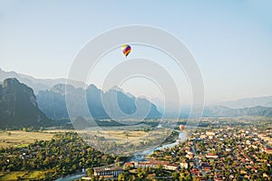 Scene of flying hot air balloon over city