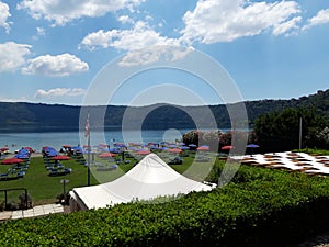 Scene from the lake of Castel Gandolfo with umbrellas and deck chairs