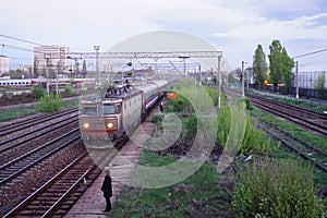 Scene of red locomotive and red train in Carpati station, Bucharest, CFR photo