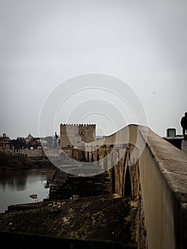 an old roman bridge over Guadalquivir river photo