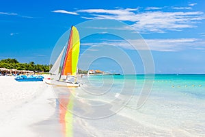 Scene with sailing boat at Varadero beach in Cuba