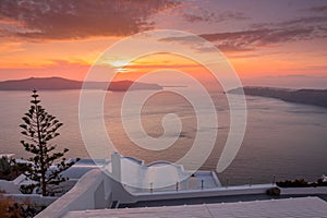 Scene of sunset overlooking the caldera and the sea in the village of Imerovigli on the island of Santorini